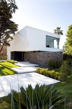 the modern house is surrounded by greenery and trees