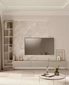 a living room filled with furniture and a flat screen tv mounted on a wall next to a book shelf