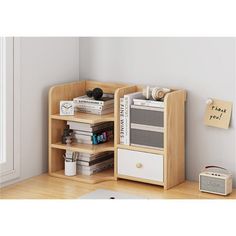 a book shelf with books and other items on it in a room next to a window