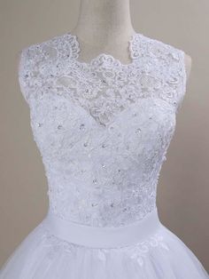 a white wedding dress on a mannequin