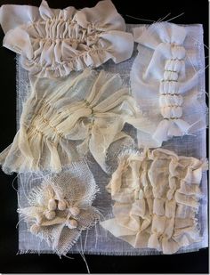 several pieces of white fabric with flowers on them, including one piece of cloth and the other part of lace