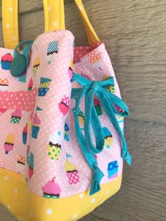 This is a little girls tote bag. It is 9.8 inches wide, 8 inches tall, and is about 5 inches deep. It is fully lined and has batting to give it a firmer form. It has an inside pocket going around the whole inside that has dividers to keep it neat and an outside button. On the sides are little bows that can be Tighten or let out depending on how much is in the bag. It is made from high quality quilting fabric for durability. Fabric Tote Bag, Scrap Quilt Patterns, Girls Tote, Scrap Quilt, Fabric Tote Bags, Scented Sachets, Fabric Tote, Lavender Sachets, Top Handle Bags