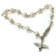 This pearl bracelet created by Jewelry By Carmal is made of: white freshwater pearls, sterling silver: dove charm, spring ring clasp and findings. This bracelet measures 7 1/2 inches in length. View more beaded bracelets: http://www.etsy.com/shop/jewelrybycarmal?section_id=8002918 Pearl is the birthstone for June and the gemstone for the 3rd and 30th Wedding Anniversaries. All of our jewelry arrives wrapped and ready for gift giving! We offer free standard shipping (via USPS) within the United S Wedding Rosary Bracelet With Pearl Charm, Elegant Pearl Jewelry For Confirmation, Elegant Pearl Bracelet For First Communion, Elegant Pearl Bracelet With Pearl Charm For First Communion, Elegant Silver Pearl Bracelet For First Communion, White Pearl Charm Bracelet For First Communion, Pearl Bracelet For First Communion, White Pearl Bracelet For First Communion, Pearl White Bracelet For First Communion