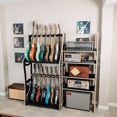 there is a guitar rack with many guitars on it