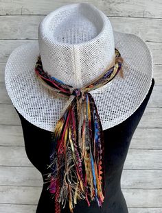 This vibrant hat band will add a festive splash of color to a variety of hats all throughout the year!  This hat band will make quite the statement worn on any color hat!   Made with unique specialty yarn of beautiful colors and textures, each band comes pre knotted to fit the standard size hat of 24" but the back knot can be untied and adjusted if needed.  The tail part of this hat band measures 10 inches.  If a different tail length is desired please just note it on the order. The width of the Multicolor Fedora With Curved Brim For Rodeo, Multicolor Fedora With Short Brim For Rodeo, Multicolor Adjustable Fedora For Kentucky Derby, Multicolor Bohemian Straw Hat For Kentucky Derby, Bohemian Multicolor Straw Hat For Kentucky Derby, Adjustable Multicolor Fedora For Kentucky Derby, Multicolor Short Brim Fedora For Rodeo, Trendy Multicolor Hat For Festivals, Handmade Country Style Hat Bands For Kentucky Derby