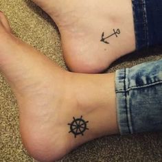 two people with tattoos on their legs and one has an anchor, the other is a wheel