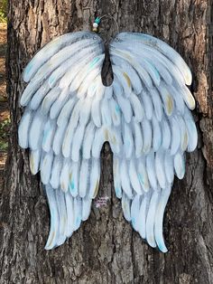 a tree with white wings attached to it