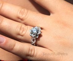 a woman's hand with a diamond ring on top of her finger and an engagement band