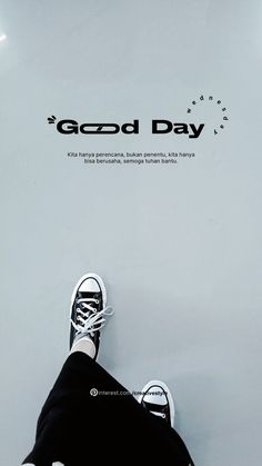 a person standing on top of a white floor next to a sign that says good day