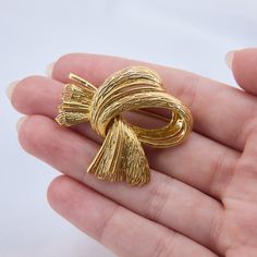 This French hallmarked scarf motif brooch pin features textured 18k yellow gold and it is finished with a trombone clasp and pin stem.  The brooch measures approximately 1.25 inches by 1.75 inches. Luxury Gold Lapel Pin For Evening, Luxury Gold Pins For Anniversary, Elegant Gold-tone Brooches For Gifts, Formal Yellow Gold Brooch Pins, Elegant Gold-tone Brooches For Formal Occasions, It Is Finished, Vintage Scarf, Trombone, Brooch Pin