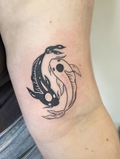 a black and white koi fish tattoo on the leg