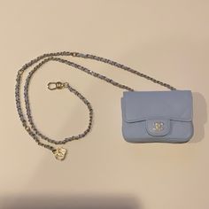 Presented Here Is The Extremely Rare And Highly Collectible New In Box Chanel Mini Purse /Belt Bag. This Gorgeous Bag Is Comprised Of Light Blue Caviar Leather. The Mini Bag Measures 4.25 Inches By 3 Inches By 1.4 Inches. The Mini Bag Is Connected To A Chain Belt Which Is The Iconic Chanel Chain Weave. The Chain Measures 39.75 Inches. The Chain Connects With A Clasp. There Is A Cc Logo On The End Of The Chain. The Bag Is New And Comes With Box And Dust Bag. This Bag Is Sold Out In Most Boutiques Luxury Blue Bag As Fashion Accessory, Luxury Blue Stylish Bag, Blue Rectangular Bag With Pearl Handle, Luxury Blue Bag, Blue Shoulder Bag For Everyday Luxury, Blue Luxury Evening Bag With Removable Pouch, Luxury Shoulder Bag With Pearl Handle For Everyday, Luxury Blue Evening Bag With Removable Pouch, Elegant Blue Bag With Pearl Handle