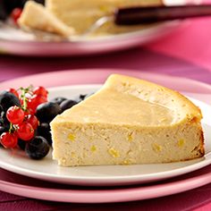 a piece of cheesecake on a plate with berries