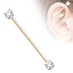 an ear piercing is shown with two different colored barbells and one has a single crystal