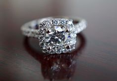 a diamond ring on top of a wooden table