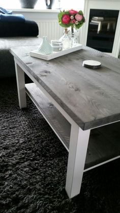 a wooden table sitting on top of a carpeted floor