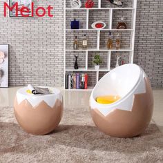 two egg shaped tables sitting on top of a carpeted floor in front of a brick wall