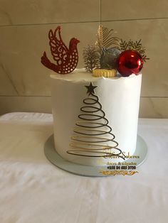 a white cake decorated with christmas decorations