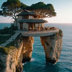 the house is built into the cliff above the water