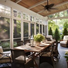 a dining room table with chairs and a ceiling fan in front of an enclosed patio area