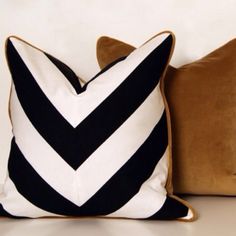 two black and white pillows sitting next to each other