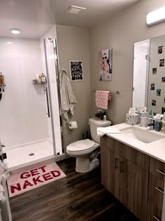 a bathroom with a sink, toilet and bathtub next to a walk in shower