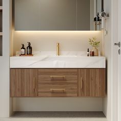 a bathroom sink with wooden cabinets and white counter top