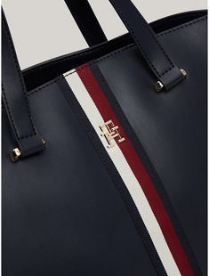 Tommy Hilfiger women's bag. Signature branding and gold-tone hardware set the tone of this sophisticated tote bag, complete with dual carry handles for comfortable toting. It also features side zips and an expandable lining to change its shape and add room to the main compartment.  Material: 100% Polyurethane. Tommy Hilfiger Bags With Zipper Closure For Everyday Use, Tommy Hilfiger Rectangular Leather Bag, Tommy Hilfiger Bags With Zipper For Everyday, Tommy Hilfiger Leather Shoulder Bag For Daily Use, Everyday Tommy Hilfiger Bag With Zipper Closure, Elegant Tommy Hilfiger Leather Shoulder Bag, Elegant Tommy Hilfiger Leather Bag, Classic Tommy Hilfiger Everyday Bag, Chic Tommy Hilfiger Leather Bags