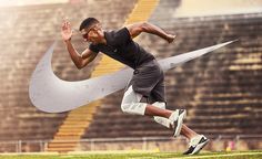 a man is running on the grass with his hands in the air while wearing sunglasses