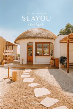 the cover of sea you magazine features a thatched roof and stone pathway leading to an outside patio