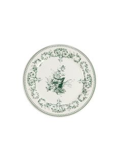 a green and white plate with an image of a bird on the front, sitting against a white background