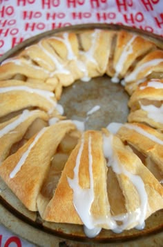 a cake with white icing sitting on top of a table