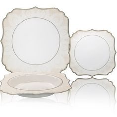 three white plates with gold trim on each one and two empty ones in the middle