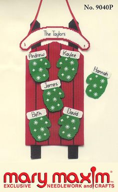 an ornament with stockings and mittens hanging from it's side on a white background