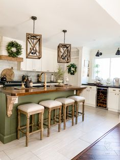 a kitchen with an island and stools in it