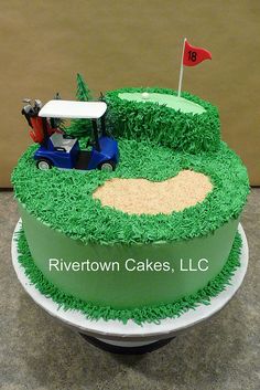 a golf themed birthday cake with green grass on top and a red flag in the middle