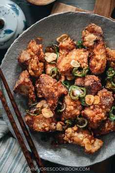 fried food on a plate with chopsticks next to it