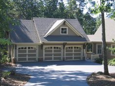 a large house with two car garages in the driveway