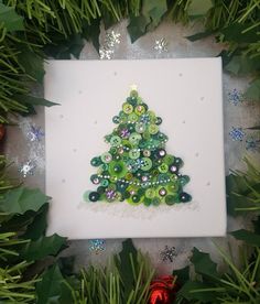 a green christmas tree made out of buttons