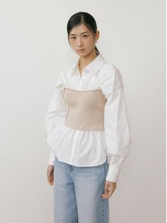 This is a minimal and feminine top by Lucirzu that is made out of high quality and sturdy material. With distinctive mood of the design and comfortable wear, you can use it for your daily lifestyle.- Knit bustier layered on top- Natural shirring with feminine look- Modern and minimal mood Chic Tops With Built-in Bra For Layering, Versatile Cotton Crop Top For Layering, Trendy Fitted Blouse For Layering, Elegant Beige Tops With Built-in Bra, Elegant Beige Top With Built-in Bra, Chic Long Sleeve Tops With Built-in Bra, Fitted Beige Tops With Built-in Bra, Beige Feminine Blouse For Layering, Spring Chic Blouse With Built-in Bra