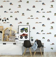 the wallpaper in this children's room has monster trucks on it