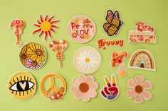 various patches and stickers on a green surface with the words happy written in them