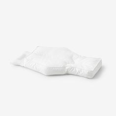 a white pillow sitting on top of a table