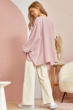 This blouse is out to prove that comfy and chic can coexist in perfect harmony. Its flowy, dolman cut gives you room to breathe while still maintaining a flattering drape. 3/4 sleeves keep it seasonal, transitioning effortlessly from summer to fall. A plunging V-neckline shows just enough skin to be subtly seductive, but the blush pink hue is as sweet and charming as an English rose garden. In short, this top lets you make a stylish statement without having to sacrifice one ounce of comfort. It’ Chic Long Sleeve Tunic For Day Out, Oversized Long Sleeve Top For Spring, Oversized Blouse With Blouson Sleeves For Fall, Chic Oversized Long Sleeve Blouse, Oversized Spring Top With Blouson Sleeves, Oversized Tops With Blouson Sleeves For Spring, Oversized Blouse With Balloon Sleeves, Oversized Blouse With Blouson Balloon Sleeves, Chic Oversized Long Sleeve Top For Spring