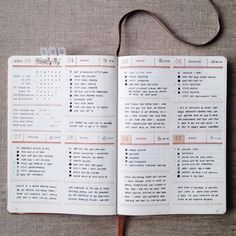 an open notebook with some writing on the pages and a cord attached to it, sitting on a table