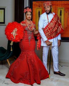 a man and woman dressed in african attire