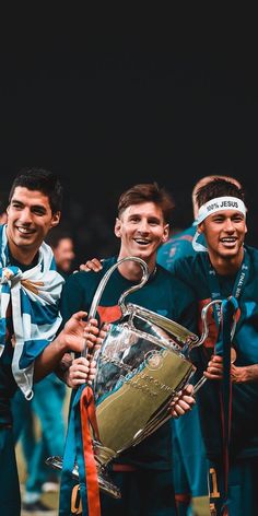 the soccer players are posing for a photo with the trophy in front of their heads