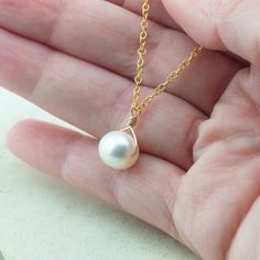 Simple, elegant, timeless white pearl necklace. This pretty pendant features a gold filed wire wrapped white, oblong freshwater pearl. The lustrous AAA-grade pearl pendant moves freely on a gold-filled chain.Chain Lengths: 16, 18, 20, and 24 inchesPendant size: 8.5-12mm (size will vary)Materials: Freshwater pearls, gold-filled chain What is gold filled? 14/20 gold-filled material is made of 14-karat gold and the gold represents 1/20th (or 5%) of the total weight of the material. Gold-filled find White Pearl Necklace, Pretty Pendant, White Freshwater Pearl, Freshwater Pearl Necklaces, Gold Filled Chain, Pearl Pendant, Pearl White, Fresh Water, Wire Wrapping