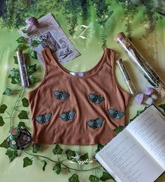 A brown tank top with embroidered moths. Brown Sleeveless Cotton Crop Top, Sleeveless Brown Cotton Crop Top, Brown Cotton Crop Top Tank Top, Brown Seamless Cotton Top, Designing Clothes, Cottagecore Outfit, Job Clothes, Future Clothes, Tech Pack