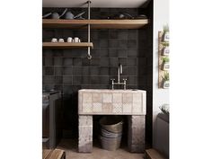 a kitchen with black tile and wooden shelves, an old washbasin sink and open shelving